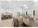 Open living space featuring a dining table, kitchen and seating area at 1667 Spring Loop Way, Winter Garden, FL 34787