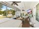 Relaxing screened-in patio with hot tub, TV, grill, dining area, and an outdoor space for entertaining at 1667 Spring Loop Way, Winter Garden, FL 34787