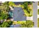 Aerial view of the home showing the house's layout, screened-in pool, mature trees, and proximity to the road at 169 Winding Oaks Ln, Oviedo, FL 32765