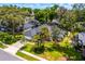 The house is surrounded by mature trees, beautiful landscaping, and a well-maintained lawn, enhancing its curb appeal at 169 Winding Oaks Ln, Oviedo, FL 32765