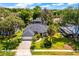 Beautiful aerial view of the home, showcasing its manicured lawn, landscaping, and tree-lined street at 169 Winding Oaks Ln, Oviedo, FL 32765