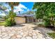 A backyard view showcasing the home's outdoor area, with a pool and patio accessible via a stone pathway at 169 Winding Oaks Ln, Oviedo, FL 32765