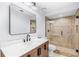 Updated bathroom featuring a vanity, shower stall with brown tiles, and a frameless mirror at 169 Winding Oaks Ln, Oviedo, FL 32765