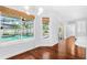 Bright dining area with pool view, hardwood floors, and modern lighting at 169 Winding Oaks Ln, Oviedo, FL 32765