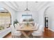 Dining room showcasing a modern chandelier, an elegant table set, and an arched window at 169 Winding Oaks Ln, Oviedo, FL 32765