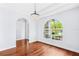 Elegant dining room with chandelier, hardwood floors and arch window at 169 Winding Oaks Ln, Oviedo, FL 32765
