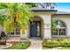 Close-up of the elegant front door and surrounding landscaping at 169 Winding Oaks Ln, Oviedo, FL 32765