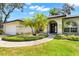 Beautiful home featuring well-manicured landscaping and a covered front entryway at 169 Winding Oaks Ln, Oviedo, FL 32765