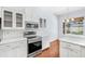 Modern kitchen features stainless steel appliances, white cabinetry, subway tile backsplash, and hardwood floors at 169 Winding Oaks Ln, Oviedo, FL 32765