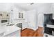 Clean kitchen featuring white cabinets, a stainless steel sink, and hardwood flooring at 169 Winding Oaks Ln, Oviedo, FL 32765