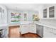 Bright kitchen with white cabinets, stainless appliances, and hardwood floors at 169 Winding Oaks Ln, Oviedo, FL 32765