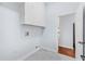 Clean laundry room with overhead cabinetry and neutral tile flooring at 169 Winding Oaks Ln, Oviedo, FL 32765