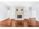 Open-concept living room with decorative fireplace, cabinets, and hardwood floors at 169 Winding Oaks Ln, Oviedo, FL 32765