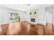 Bright living room with fireplace, hardwood floors, cabinets, and patio access at 169 Winding Oaks Ln, Oviedo, FL 32765