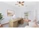 Bright office space with a large desk, hardwood floors, and natural light from backyard access at 169 Winding Oaks Ln, Oviedo, FL 32765