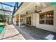 Large covered patio featuring outdoor kitchen, ceiling fans, and pool access at 169 Winding Oaks Ln, Oviedo, FL 32765