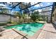 A screened-in pool with a hot tub, waterfall feature, and brick paver deck provides a relaxing outdoor space at 169 Winding Oaks Ln, Oviedo, FL 32765