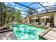 Screened pool area featuring lounge chairs and lush landscaping at 169 Winding Oaks Ln, Oviedo, FL 32765