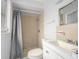 Standard bathroom features a shower with tile surround and a white vanity with a sink and mirror at 1708 Nebraska Ave, Kissimmee, FL 34744