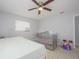 Comfortable bedroom with tile flooring, a ceiling fan, and ample space for a bed and crib at 1708 Nebraska Ave, Kissimmee, FL 34744