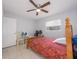 Modest bedroom with tile flooring, a ceiling fan, and a window for natural light at 1708 Nebraska Ave, Kissimmee, FL 34744