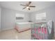 Cozy bedroom with tile flooring, a ceiling fan, and natural light from the windows at 1708 Nebraska Ave, Kissimmee, FL 34744