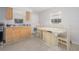 Functional kitchen featuring light wood cabinets, an adjacent dining area, and tile flooring at 1708 Nebraska Ave, Kissimmee, FL 34744