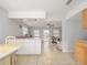Bright, open kitchen featuring white cabinetry, a breakfast bar, and tile flooring flowing into the living area at 1708 Nebraska Ave, Kissimmee, FL 34744