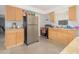 Practical kitchen with light wood cabinets, stainless steel appliances, and tile flooring at 1708 Nebraska Ave, Kissimmee, FL 34744