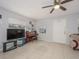 Bright living room with tile flooring, ceiling fan, and natural light from the window at 1708 Nebraska Ave, Kissimmee, FL 34744