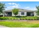 Exterior view of the back of the home with a well-manicured lawn and screened-in patio at 1855 Flora Pass Pl, Kissimmee, FL 34747