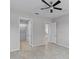 This bedroom features a ceiling fan, tile floors, and entryways to a closet and other rooms at 1855 Flora Pass Pl, Kissimmee, FL 34747