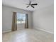 Bright bedroom with tile floors, neutral walls, ceiling fan, and large window with pleasant views at 1855 Flora Pass Pl, Kissimmee, FL 34747