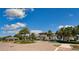 Welcoming community entrance features lush landscaping and elegant architecture with palm trees and well-maintained grounds at 1855 Flora Pass Pl, Kissimmee, FL 34747