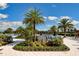 Resort-style community pool surrounded by palm trees, lounge chairs, and lush tropical landscaping at 1855 Flora Pass Pl, Kissimmee, FL 34747