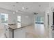 Bright and airy kitchen with a granite island and views of the outdoor living space at 1855 Flora Pass Pl, Kissimmee, FL 34747