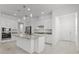 Modern kitchen featuring granite countertops, white cabinetry, and stainless steel appliances at 1855 Flora Pass Pl, Kissimmee, FL 34747