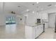 Open floor plan with kitchen island, stainless steel appliances, and access to the outdoor patio at 1855 Flora Pass Pl, Kissimmee, FL 34747
