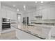 Well-equipped kitchen with granite countertops, tile backsplash, and built-in microwave at 1855 Flora Pass Pl, Kissimmee, FL 34747