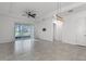 Spacious living room area with large tile flooring and access to the outdoor patio at 1855 Flora Pass Pl, Kissimmee, FL 34747