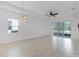 Open living space featuring tile flooring, a modern light fixture, and sliding glass doors at 1855 Flora Pass Pl, Kissimmee, FL 34747