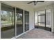 Spacious screened patio with brick floors, ceiling fan, and view of the golf course at 1855 Flora Pass Pl, Kissimmee, FL 34747