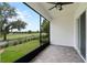 Screened patio with golf course views, brick floors, and ceiling fan at 1855 Flora Pass Pl, Kissimmee, FL 34747
