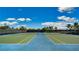 Well-maintained tennis courts offer a great recreational amenity for residents, set against a bright blue sky at 1855 Flora Pass Pl, Kissimmee, FL 34747