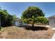 Backyard view with a shed and mature tree providing shade at 2300 Dawnwood Ln, Orlando, FL 32809