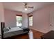 Bedroom featuring hardwood floors, two windows, and a ceiling fan at 2300 Dawnwood Ln, Orlando, FL 32809