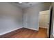 Bedroom featuring hardwood floors and a walk-in closet at 2300 Dawnwood Ln, Orlando, FL 32809