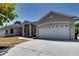 Charming home featuring a two-car garage and a well-maintained front yard with mature landscaping at 2300 Dawnwood Ln, Orlando, FL 32809