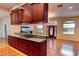 Open-concept kitchen featuring granite countertops, custom cabinets, and seamlessly flowing into the living area at 2300 Dawnwood Ln, Orlando, FL 32809