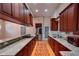 Modern kitchen with granite countertops, stainless steel appliances, and custom cabinetry for storage at 2300 Dawnwood Ln, Orlando, FL 32809